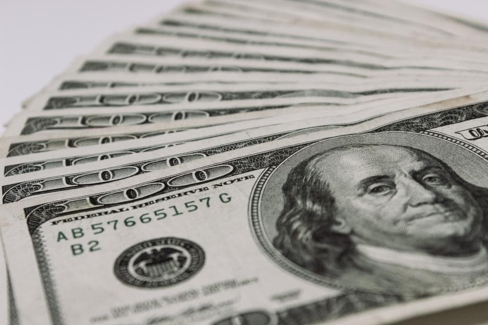 A fanned stack of United States hundred dollar bills